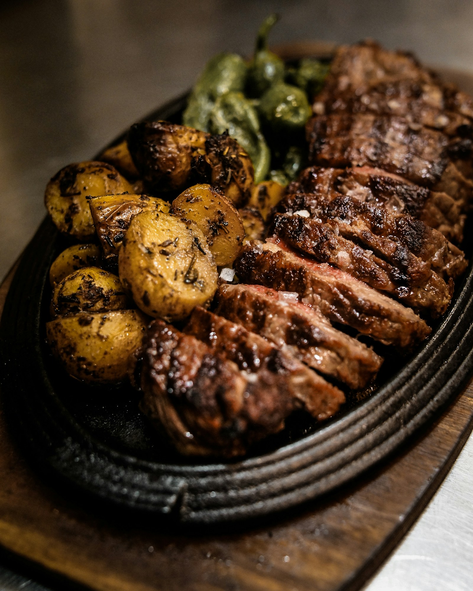 Sliced dry-aged steak on a slate board
